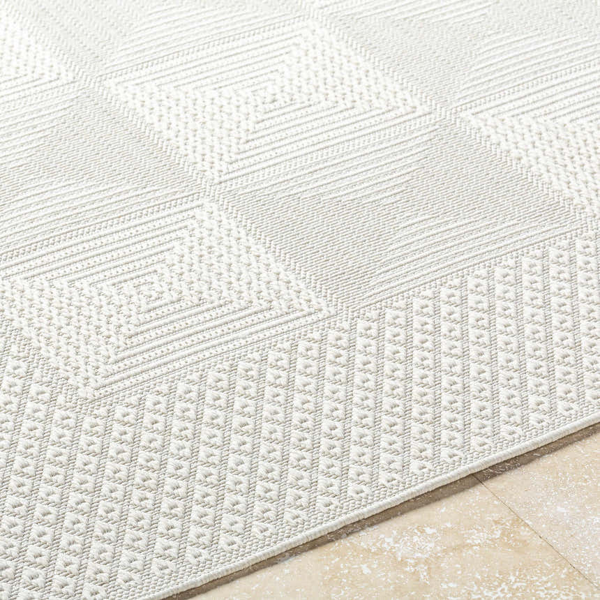 Close-up of the Anabia White Area Rug showing its geometric diamond pattern and woven texture. Texture