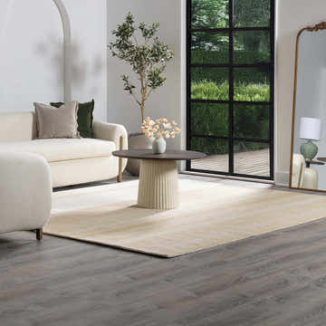 Living room with neutral sofa and Yoyko Area Rug in ash, pearl, prairie dust, and tan colors. Roomscene-Rectangle