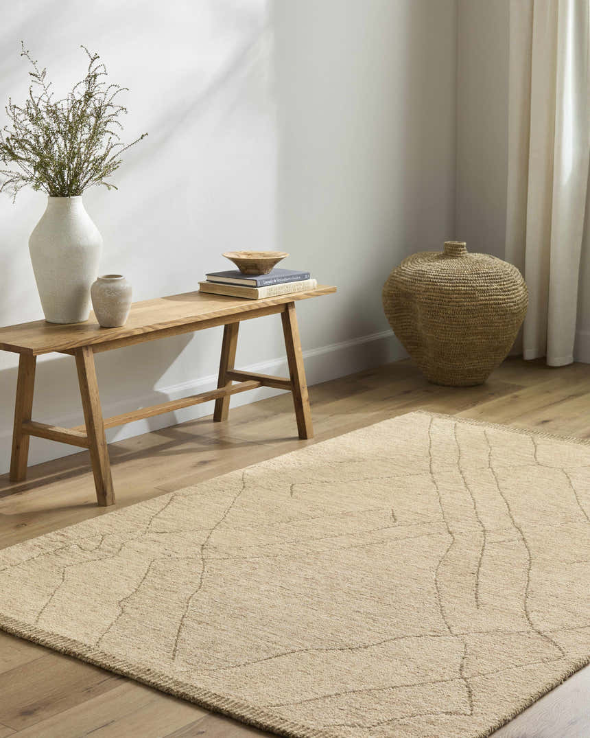 Neutral room scene with a beige Addien Area Rug, light wood floors, bench, and decorative vases. Roomscene-Rectangle