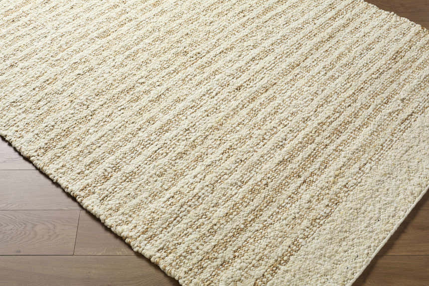 Close up of the hand woven Yaron Area Rug showing pearl and tan jute and wool texture. Corner