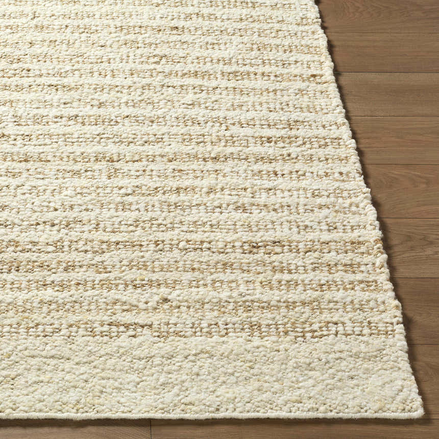 Close up of the hand woven Yaron Area Rug showing pearl and tan stripes on wood floor. Front