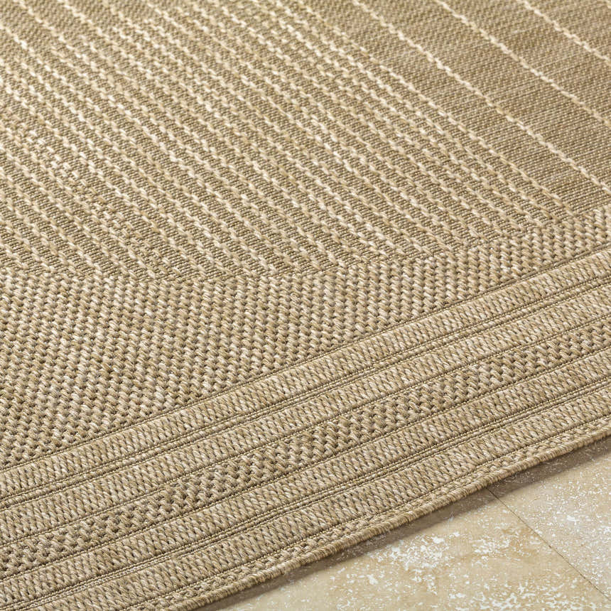 Close up of the textured, machine woven Yuley Brown Area Rug in prairie dust and tan. Texture