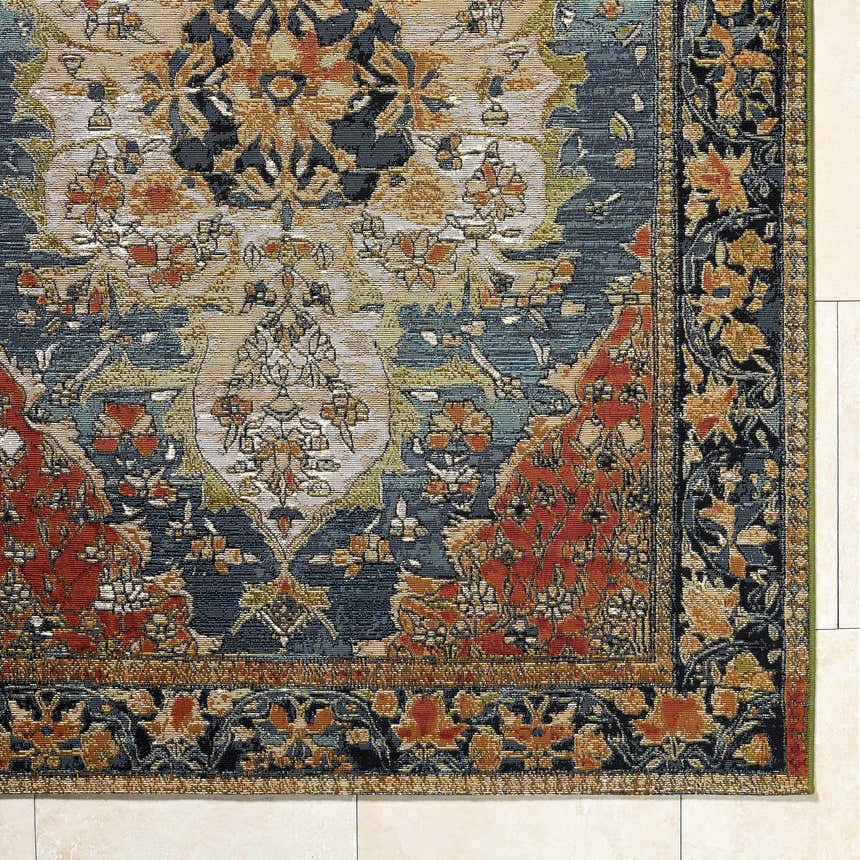 Close up of Zorea Traditional Area Rug showing floral pattern in navy, red, gold, and beige. Machine woven texture. Corner