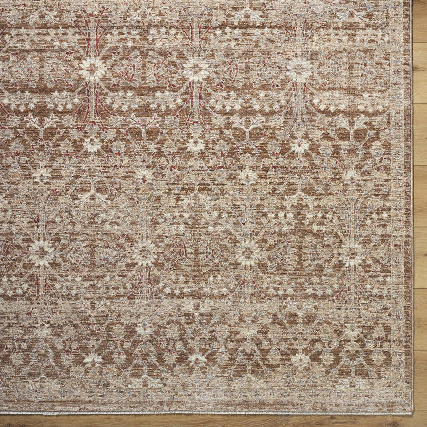 Close-up of the Ammiel Tan Area Rug. Traditional floral pattern in burnt orange, cream, dark red, gray, and tan. Corner