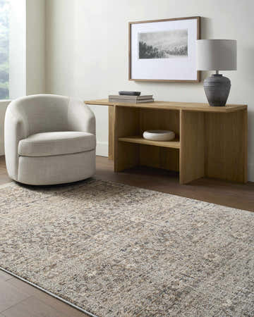 Living room scene with Ammiel Cream Area Rug, light wood console table, round chair, and neutral decor. Roomscene-Rectangle