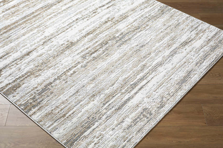 Close up of the Aminia Area Rug showing its charcoal, gray, and light brown contemporary design. Corner