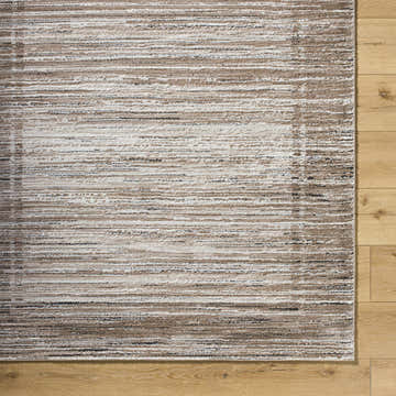 Close-up of the Ainhoa Luxe Thick Area Rug. Contemporary design in ivory, tan, and black on wood floor. Swatch
