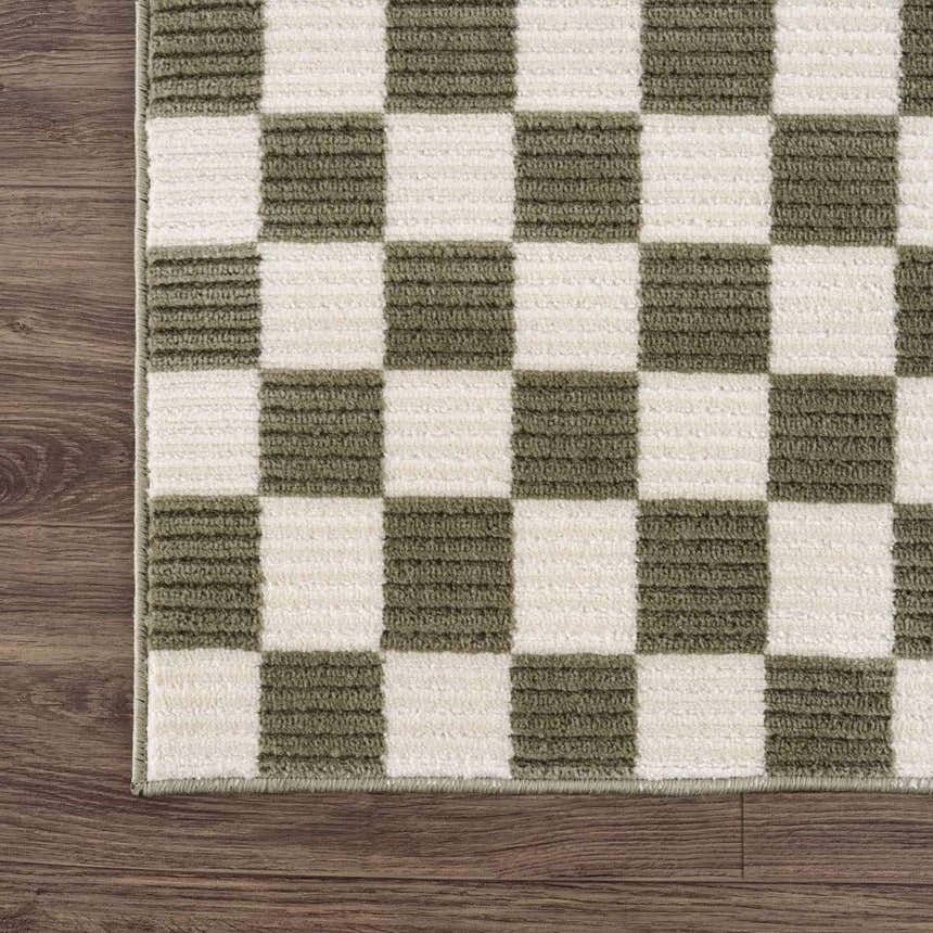Close-up of the Kaysar Olive Green Checkered Washable Area Rug showing its texture and checkered pattern on wood floor. Corner
