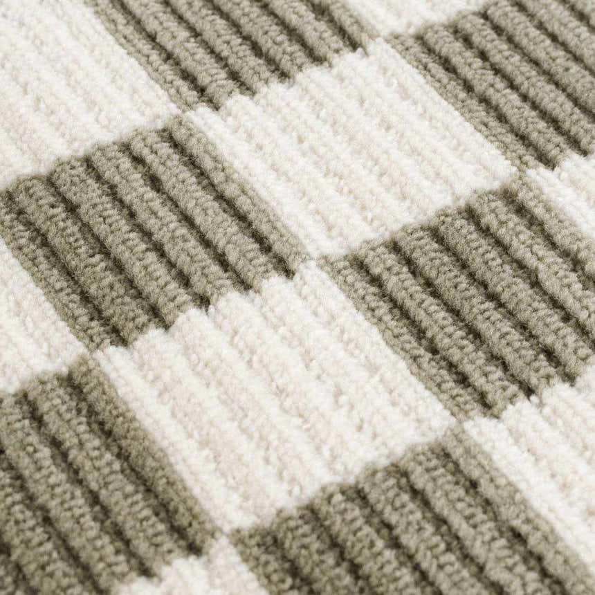 Close-up of the Kaysar Olive Green Checkered Washable Area Rug, showing its textured green and off-white checkered pattern. Texture