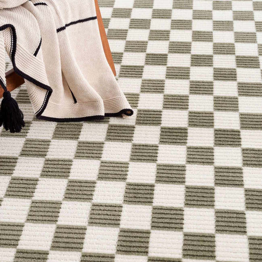Close-up of the Kaysar Olive Green Checkered Washable Area Rug, showing its green and off-white checkered pattern. Styleshot