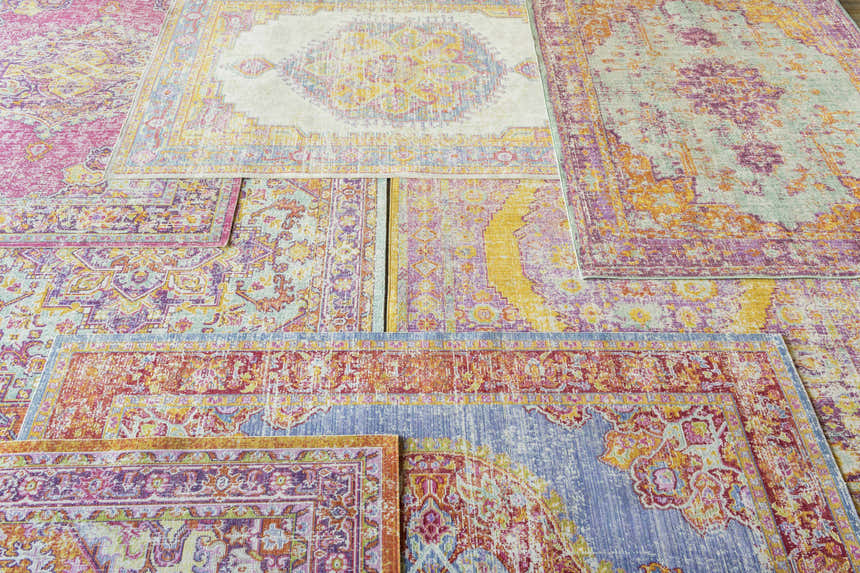 Pile of Horley Area Rugs in pink, blue, orange, and yellow. Traditional farmhouse style rugs. Clearance sale. Styleshot