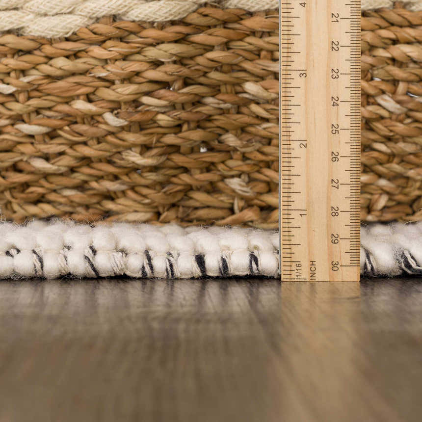 Close-up of the Ramsbury Wool Area Rug showing the texture, ivory and black fibers, and hand-woven construction. Pile
