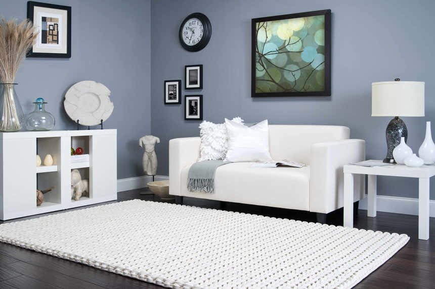 Living room scene with a cream Christoval Area Rug, white sofa, and gray walls. Contemporary style. Roomscene-Rectangle