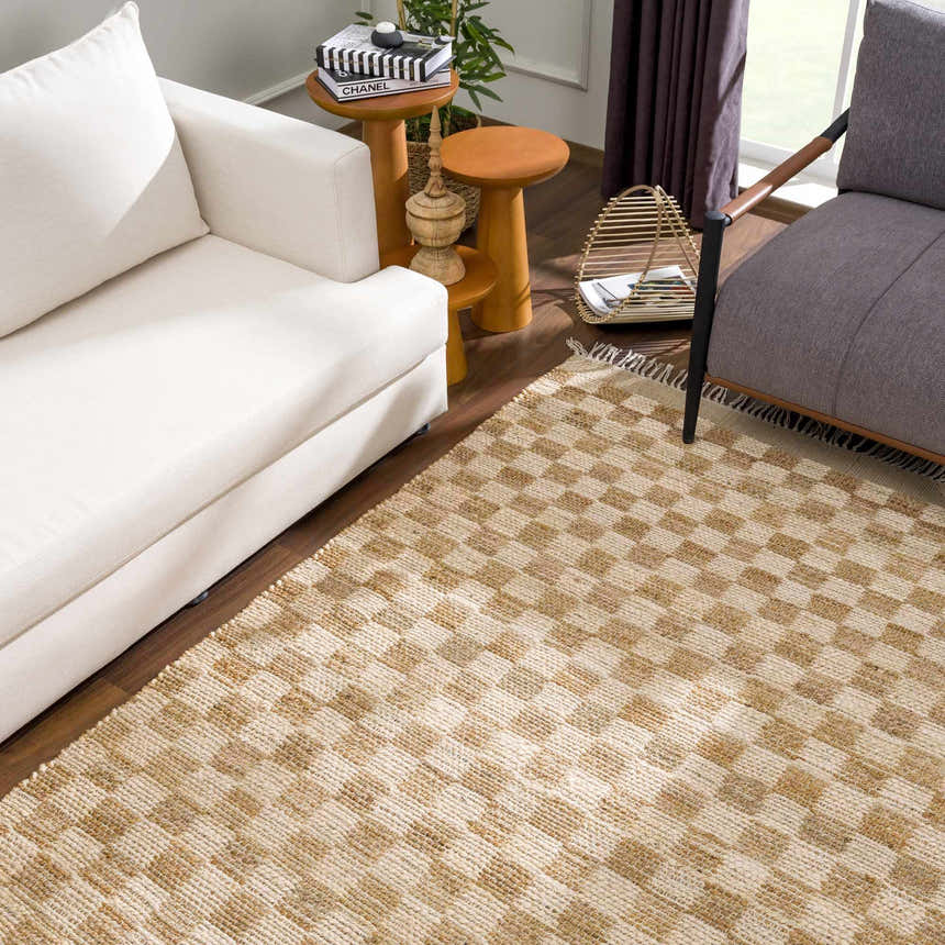 Living room scene with a beige Ionut Checkered Jute Area Rug, white sofa, gray chair, and wooden side tables. Roomscene-Rectangle