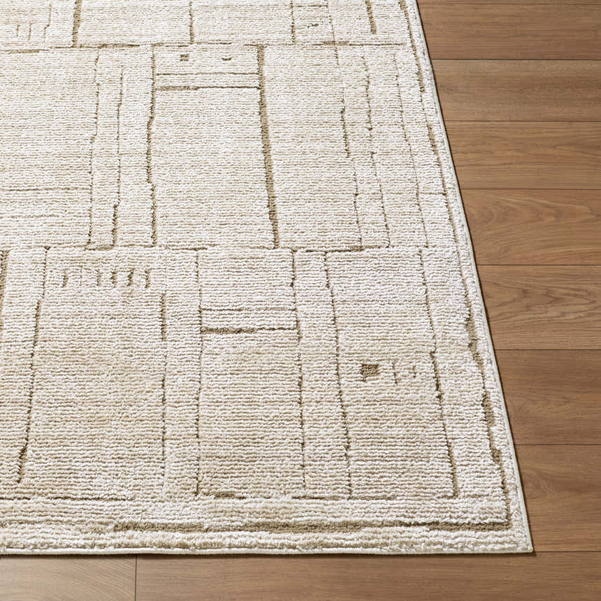 Close-up of the Alma Machine Woven Elle Decor x LIVABLISS EDAL-2300 Area Rug in dark brown and taupe on wood floor. Front