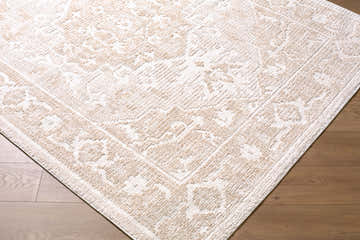 Close up of the Odeon Elle Decor x LIVABLISS EDOD-2304 Area Rug. Beige and cream tones, contemporary floral pattern. Corner