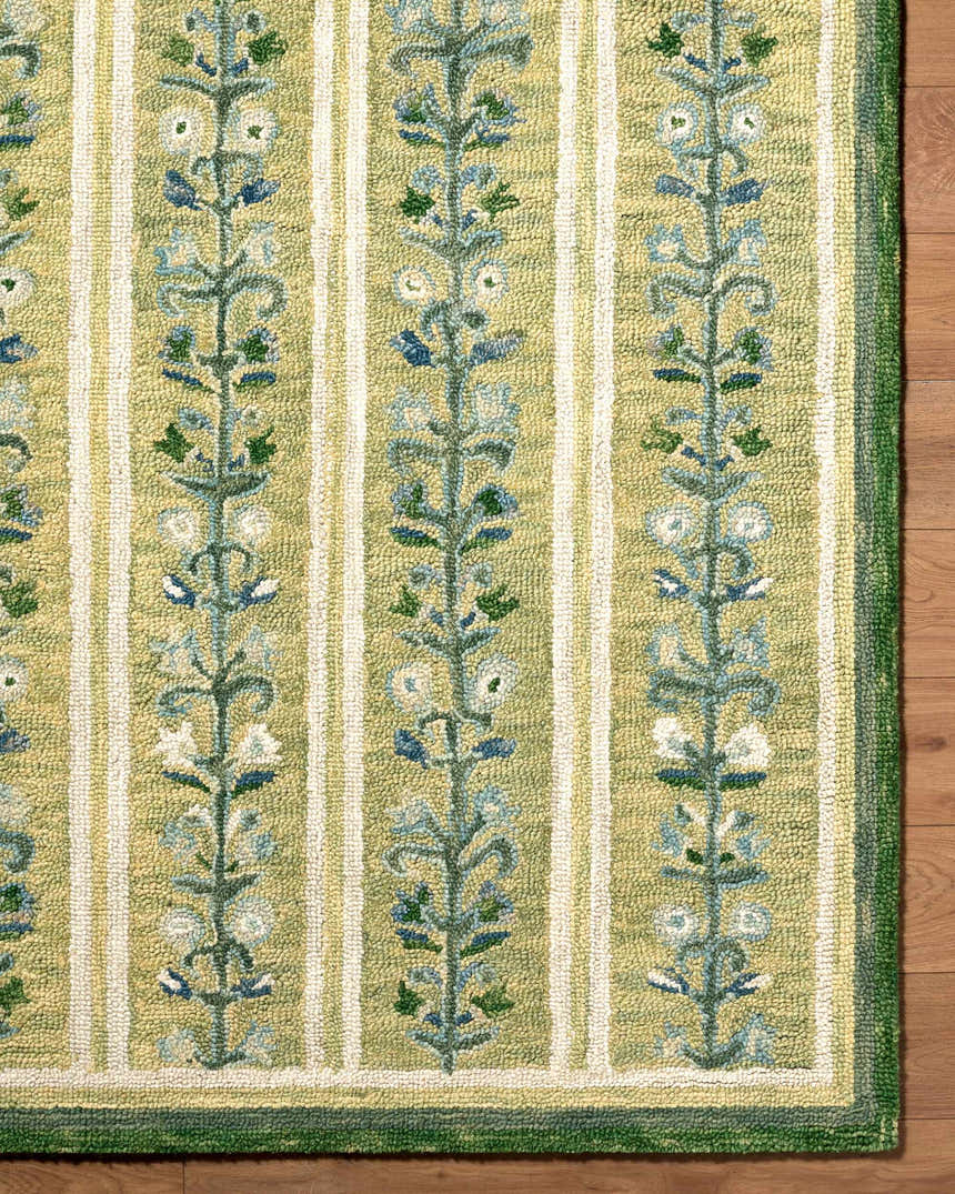 Close-up of the hand-tufted Callen Light Green Area Rug, featuring a floral vine pattern and striped design. 100% wool texture. Front