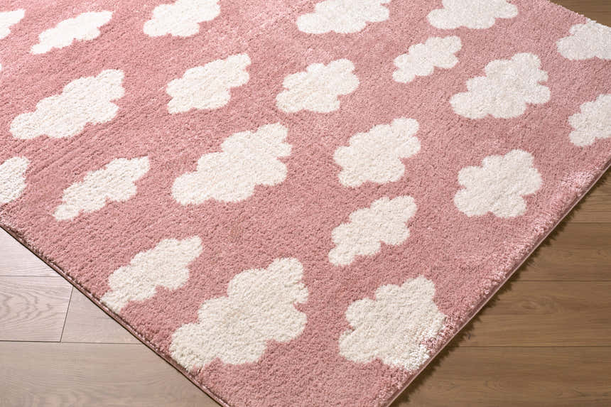 Close-up of the Dawo Pink Abstract rug. Features a pink background with a white cloud pattern and a soft, textured feel. Corner
