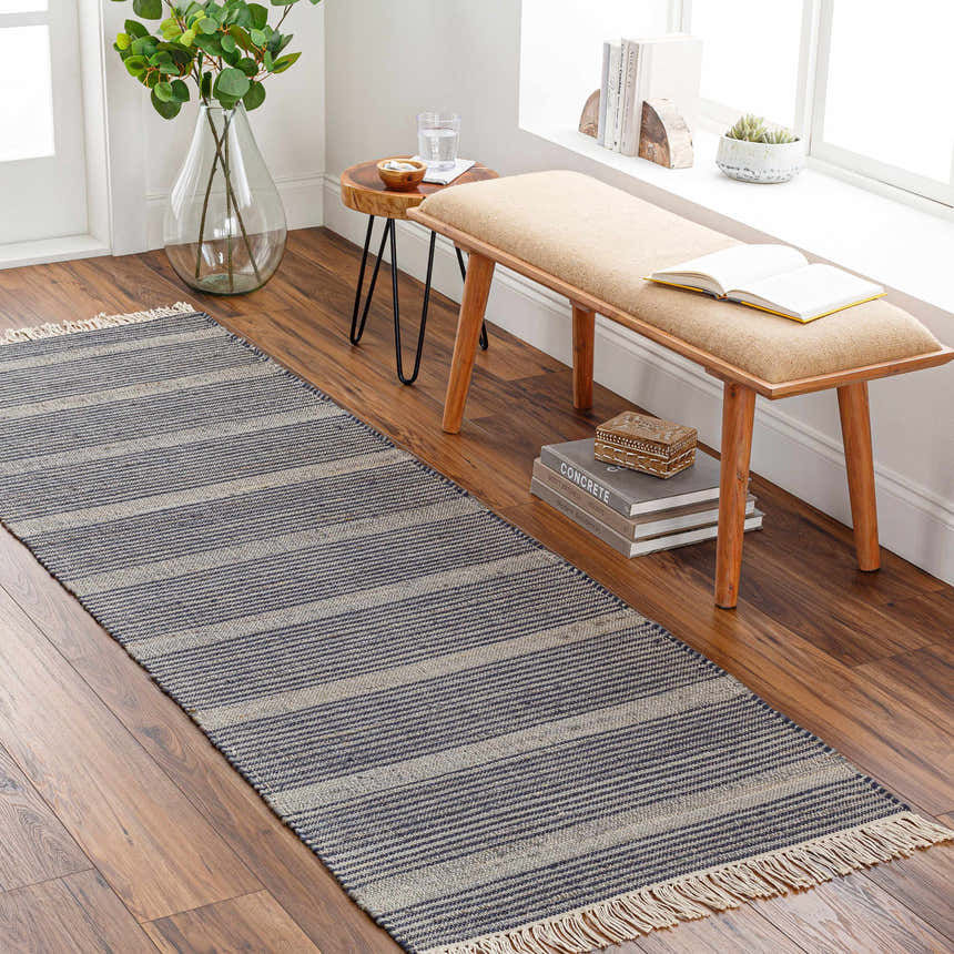 Entryway scene with a navy and off-white striped Gambalidio Area Rug runner, wood bench, and hardwood floors. Roomscene-Runner