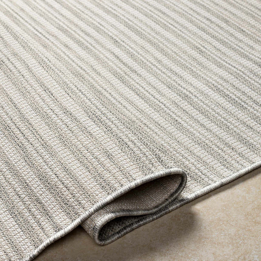 Close-up of the Greg Area Rug showing lambswool, multi brown, and smoke colors with a textured, machine-woven design. Fold