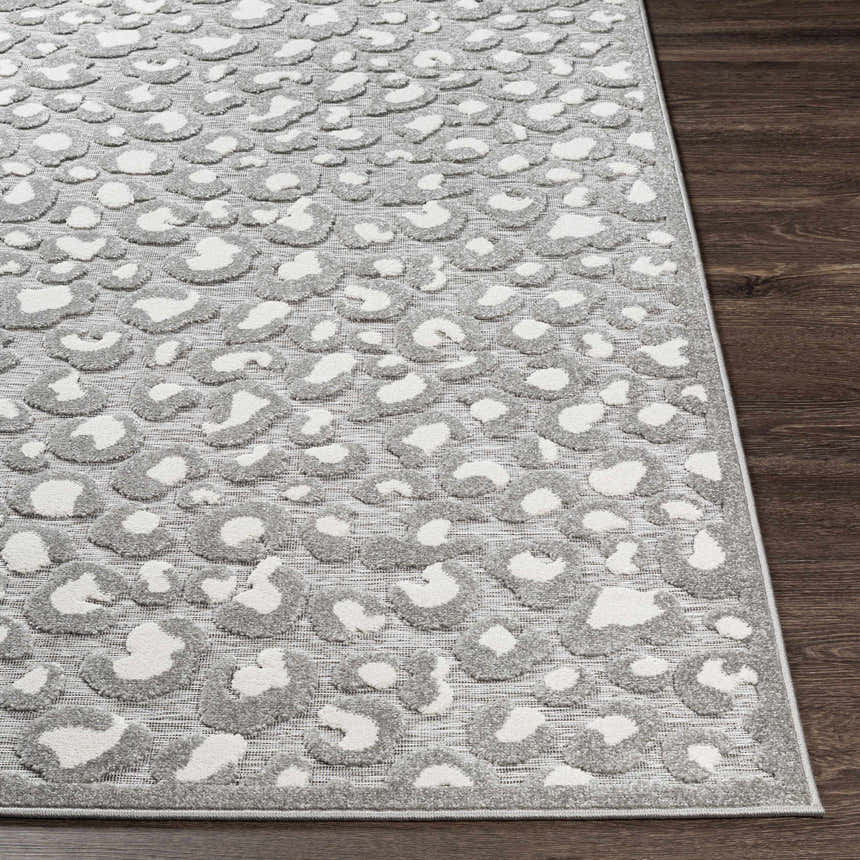 Close-up of the Greensborough Performance Rug. Gray and white animal print on a textured, machine-woven polypropylene rug. Front