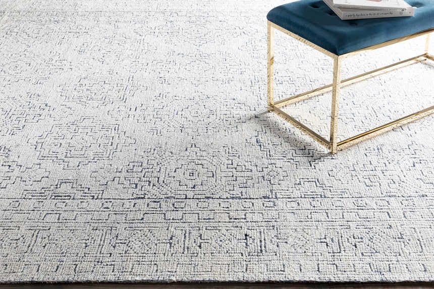 Close-up of the Ipplepen Area Rug showing its blue and white geometric pattern and hand-knotted texture. Styleshot