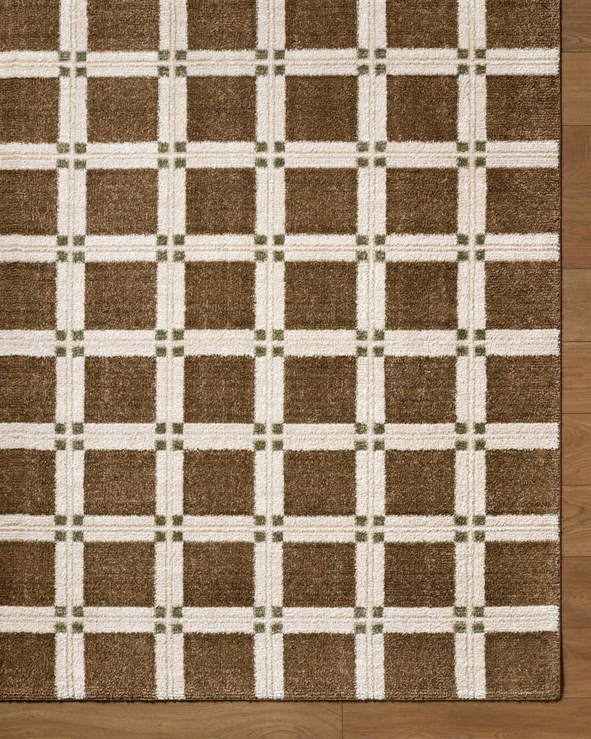 Close-up of the Kalkin Brown Area Rug featuring a brown, off-white, and olive green plaid pattern. Corner