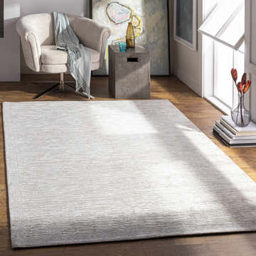 Living room scene with a light beige Mardi Area Rug, chair, and modern decor. Roomscene-Rectangle