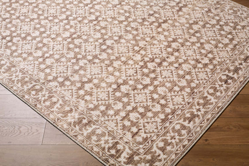 Close-up of the Aram Machine Woven Nabela Noor Home x LIVABLISS NBAR-2307 Area Rug with a traditional brown pattern. Corner