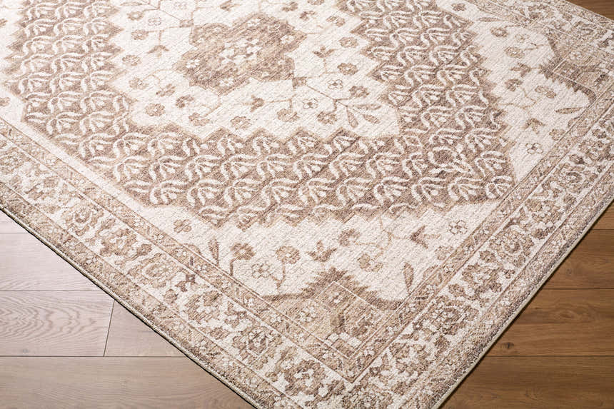 Close-up of the Athiyo Machine Woven Nabela Noor Home x LIVABLISS NBAT-2305 Area Rug, showing its brown traditional pattern and texture. Corner
