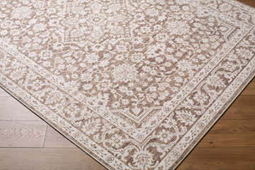 Close-up of Maan Machine Woven Nabela Noor Home x LIVABLISS NBMA-2306 Area Rug. Dark brown traditional pattern on light background. Corner