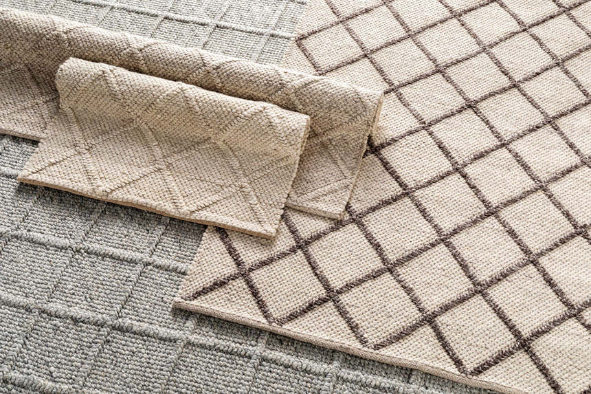 Close-up of the hand woven Syosset Cream/Brown Trellis Wool & Viscose Rug, showing its diamond pattern and wool texture. Styleshot