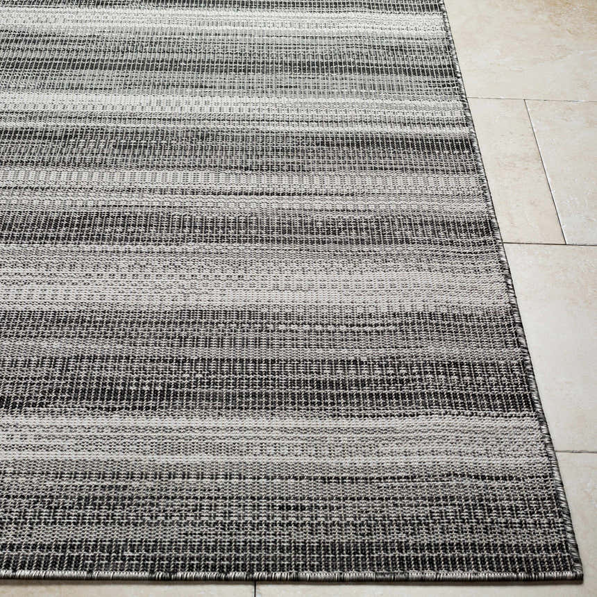 Close-up of the Kris Black Area Rug showing its woven texture and horizontal stripes in beachhouse and dark gray. Front