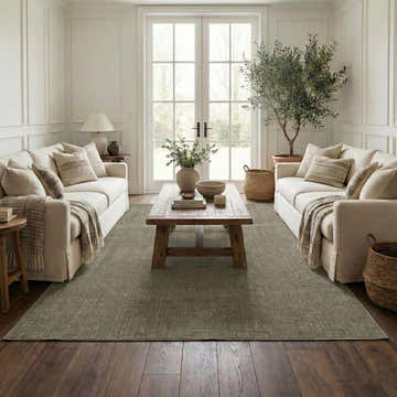 Living room scene with two sofas and a Leanna Green Washable Area Rug in gray green, over dark wood floors. Roomscene-Rectangle