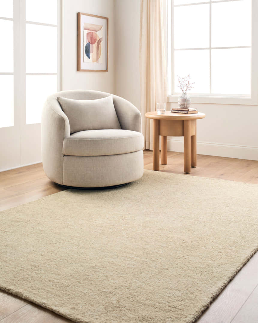 Neutral living room with a beige swivel chair and the Fupue Beige Abstract Area Rug. Roomscene-Rectangle