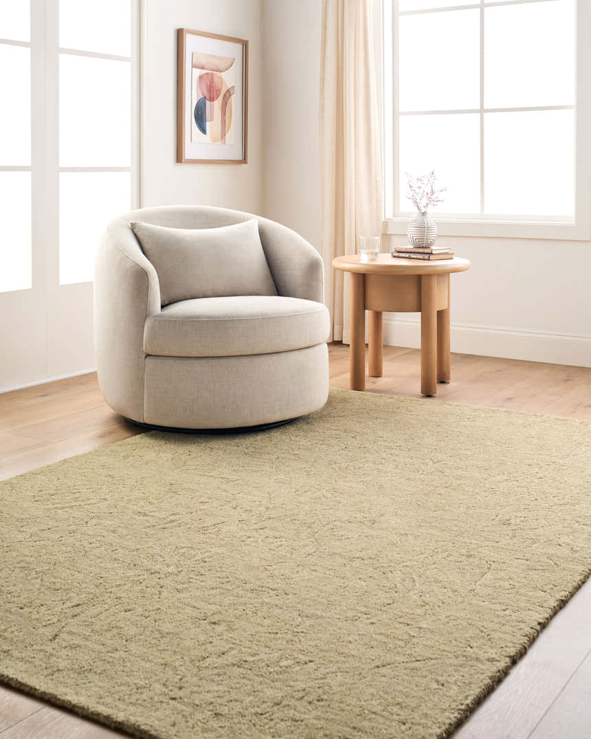 Neutral living room with beige swivel chair and Rachel Zoe x LIVABLISS RZNE-2303 area rug in sandstone. Roomscene-Rectangle