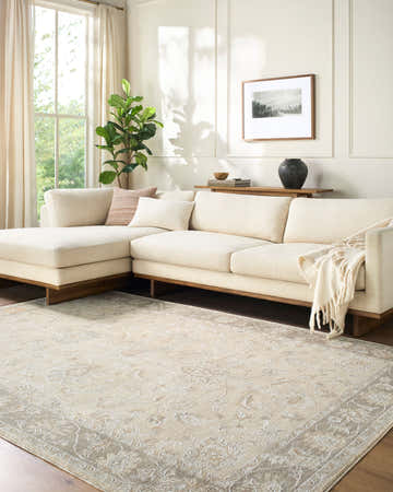 Living room with beige sectional sofa and the Vintage Edit Rachel Zoe x LIVABLISS RZVE-2304 area rug in beige, cream, and gray. Roomscene-Rectangle