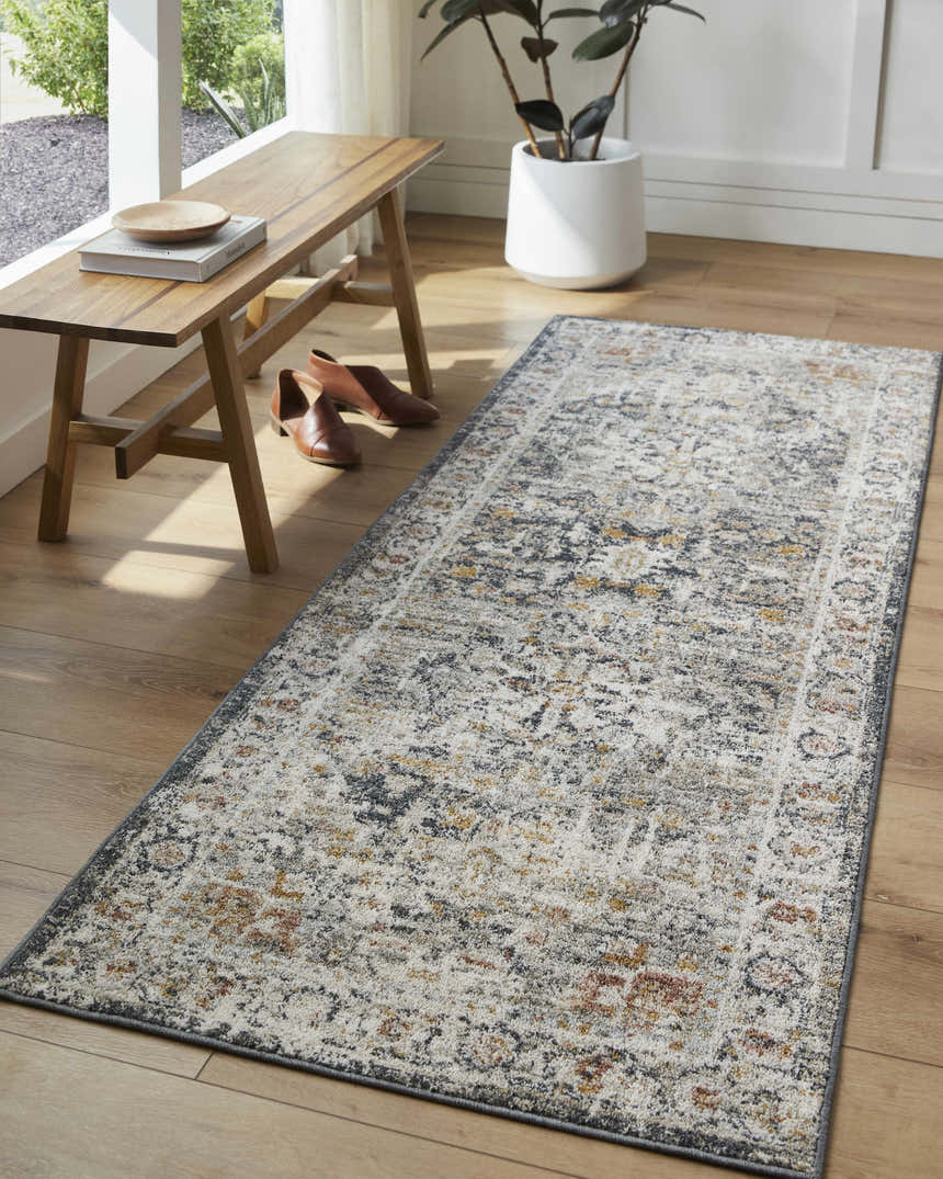 Entryway with wood bench, shoes, and Ivria Navy & Rust Area Rug. The rug is runner-shaped with a traditional, distressed pattern. Roomscene-Runner