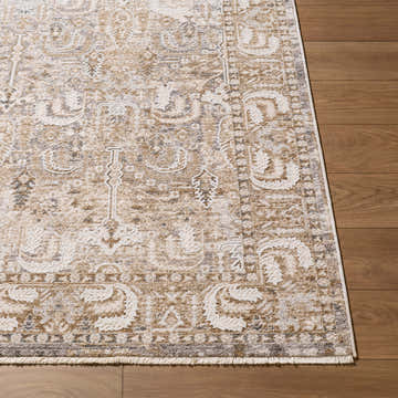 Close-up of the beige, cream, and gray Karsen Area Rug featuring a traditional, ornate pattern on a wood floor. Front
