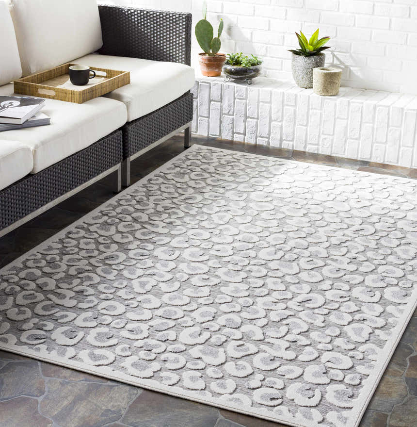 Modern patio with white sofa and Seascale Outdoor Carpet. Gray animal print rug on stone tile floor. Roomscene-Rectangle
