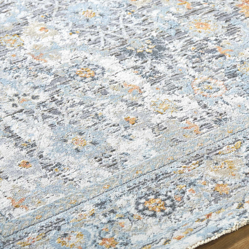 Close-up of the Finn Silver Blue Area Rug, showcasing its silver, gray, and blue tones and traditional floral pattern. Texture