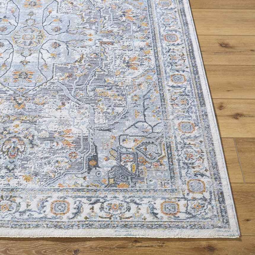 Close-up of Hewez Area Rug in cloud gray, dark gray, and nutmeg on wood floor. Traditional floral pattern. Front