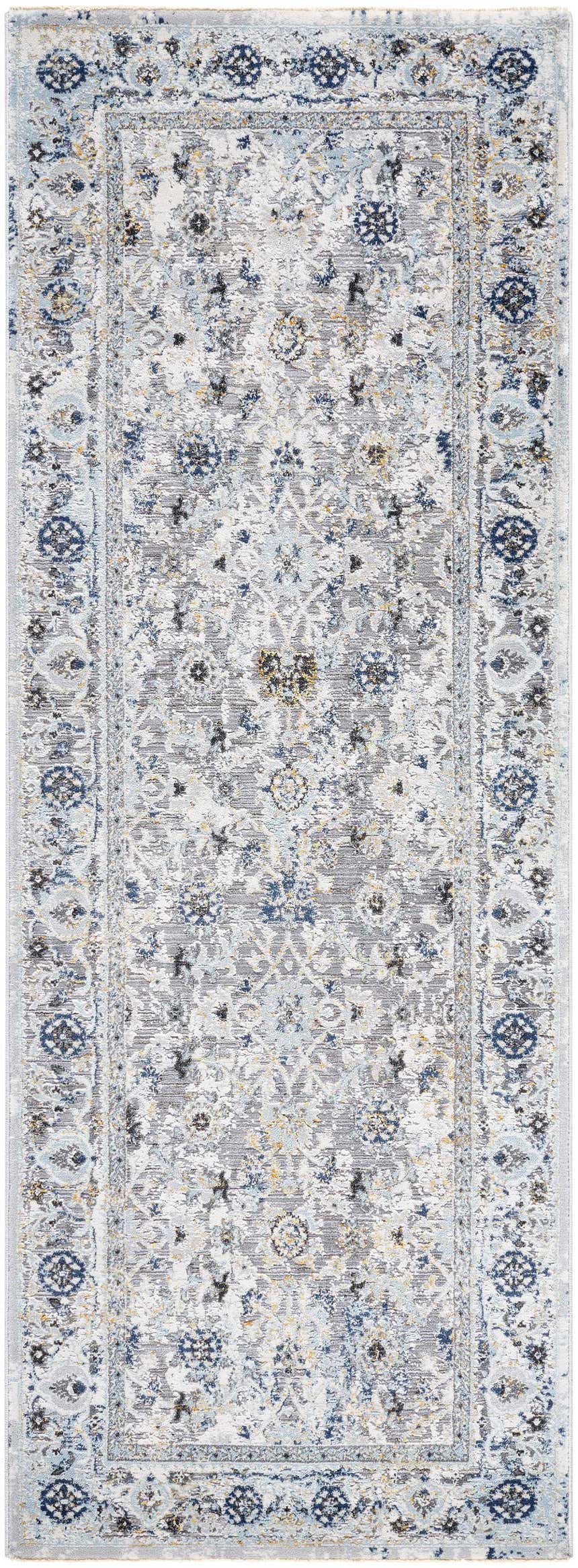 Close-up of the Irida Area Rug. Machine-woven rug in dark gray, denim, and light gray with a traditional floral pattern. Design-Runner-2773