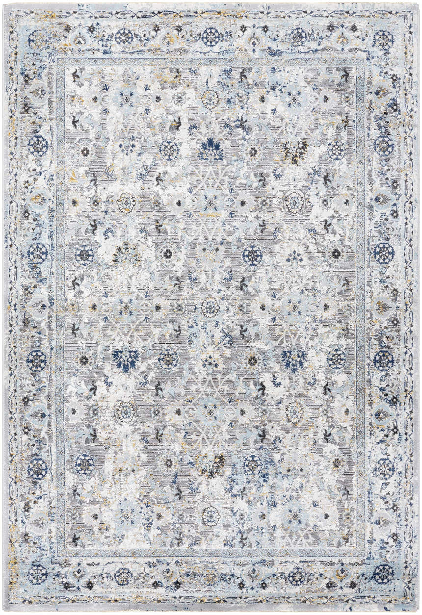 Close-up of the Irida Area Rug in dark gray, denim, and gray. Features a traditional floral pattern and machine-woven construction. Design-Rectangle-575