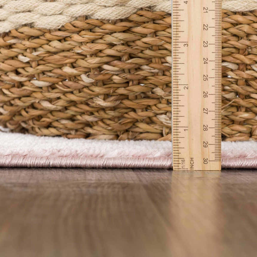 Close-up of the Kandos Blush & Light Pink Area Rug showing the pile height with a ruler for scale. Pile