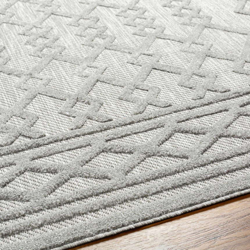 Close-up of the Kort SFG-2310 area rug. Bone, natural gray, and taupe geometric pattern with a textured, machine-woven design. Texture