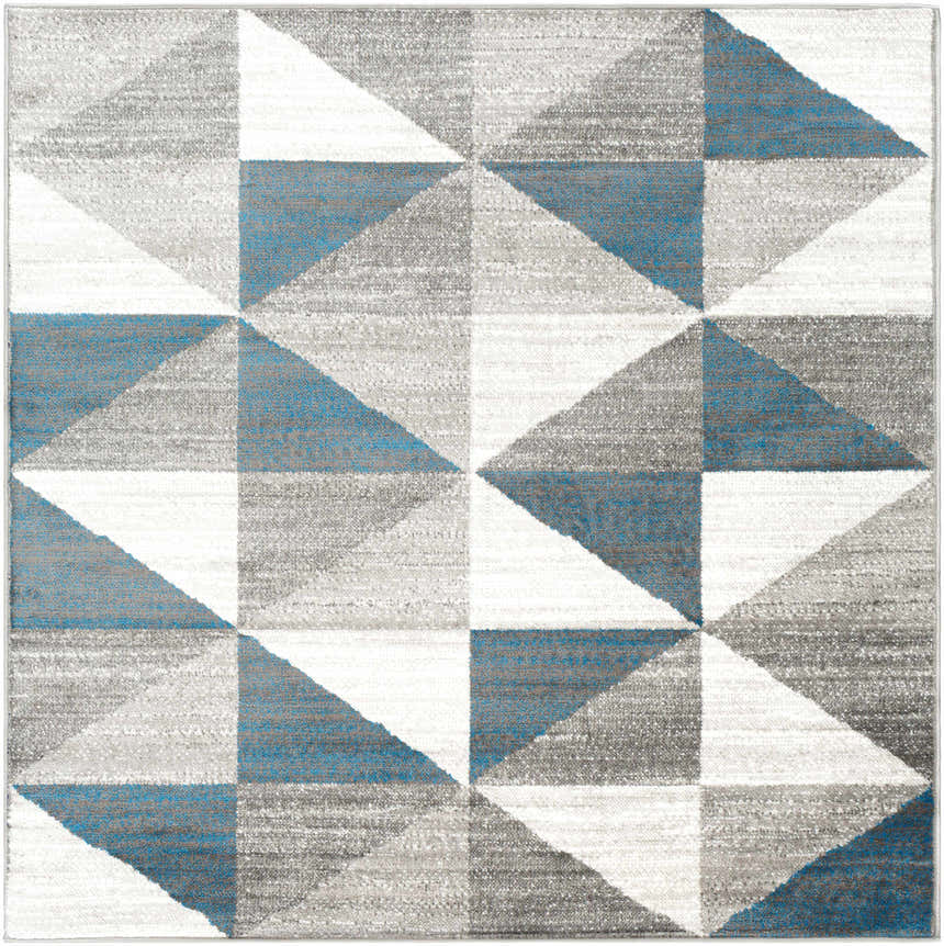 Close-up of the Volant Area Rug featuring a geometric triangle pattern in blue, gray, light gray, and white. Design-Square-53
