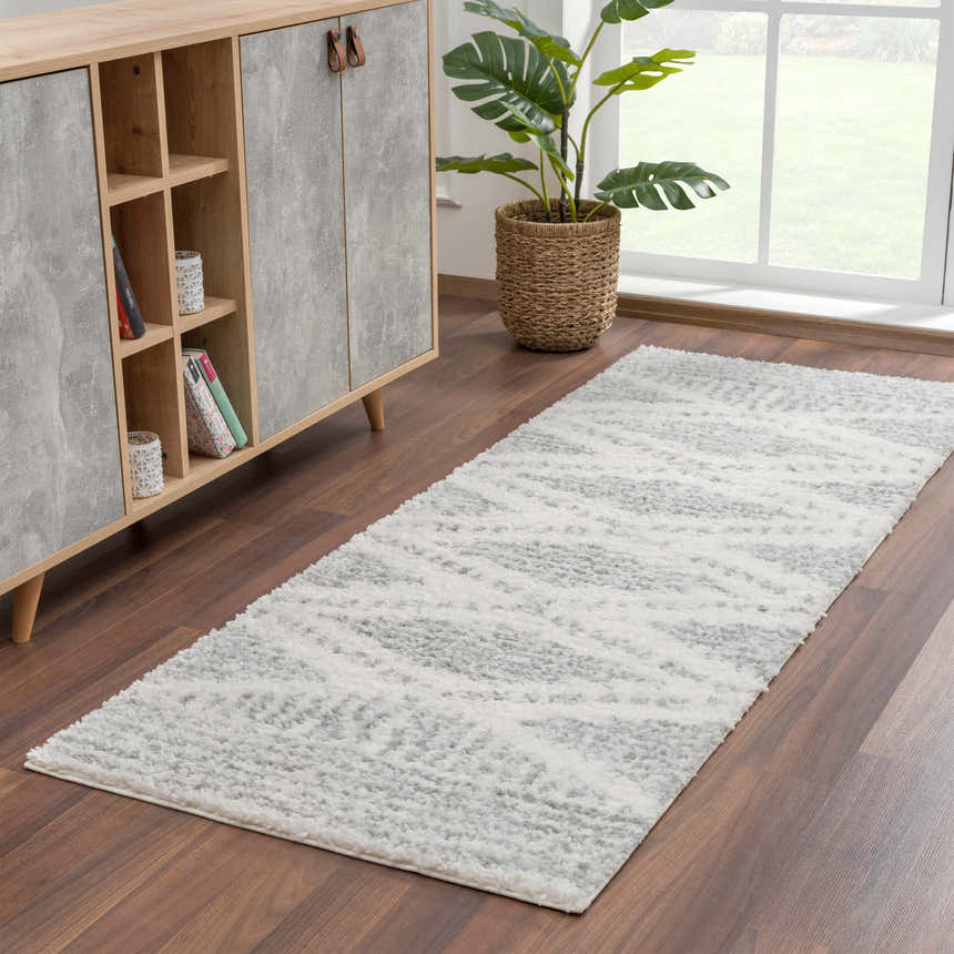 Hallway scene with gray Trunding Plush Area Rug, wood cabinet, and potted plant near a window. Roomscene-Runner