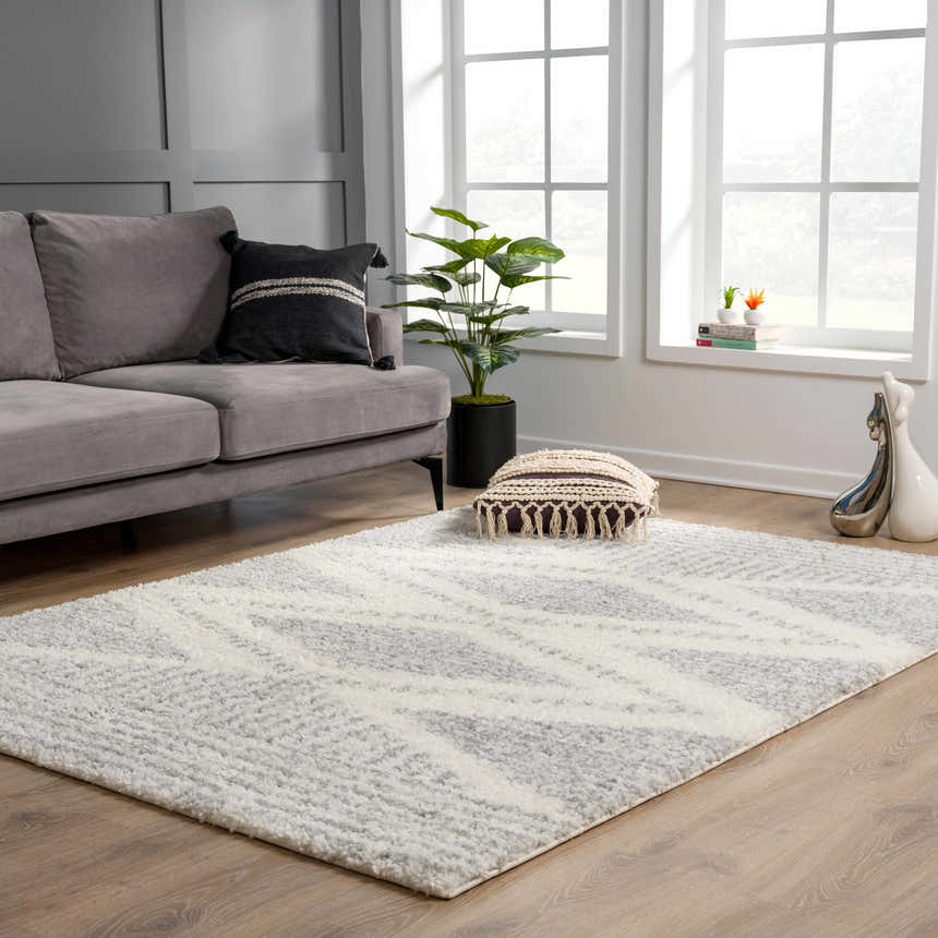 Living room scene with a gray sofa and the Trunding Plush Area Rug in Gray with a geometric pattern. Roomscene-Rectangle