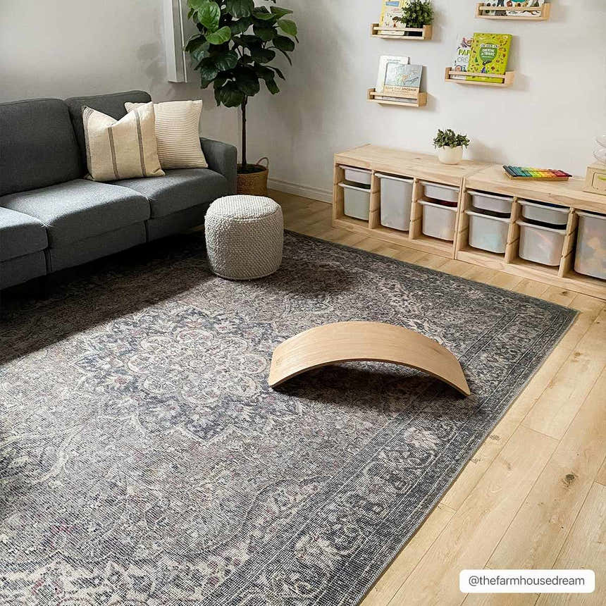 Kids room with gray sofa and Greenpoint Dusty Blue Washable Rug. Oriental rug with vintage pattern, wood floors, and toy storage. Roomscene-Rectangle